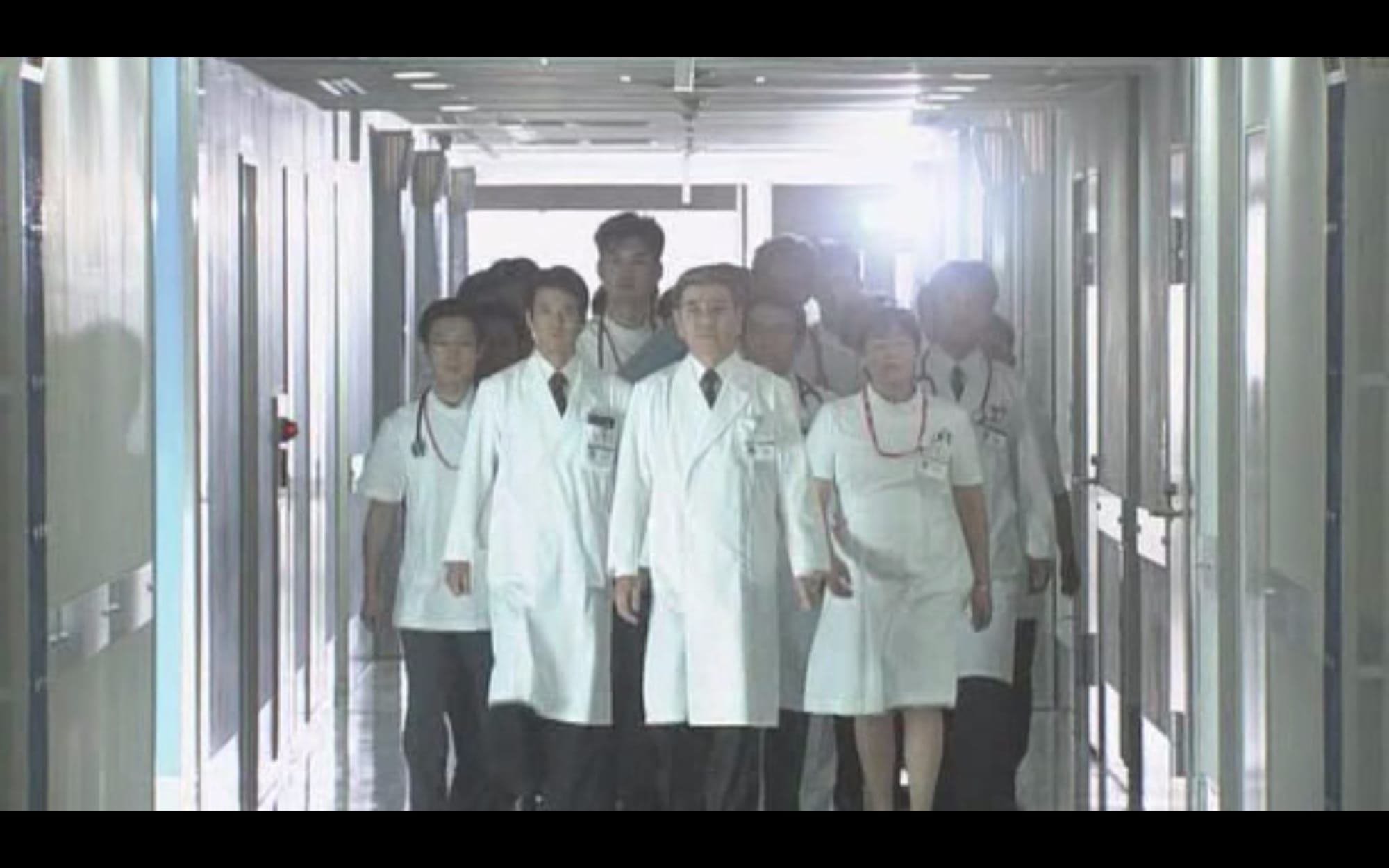 doctors walk en masse through hospital corridors