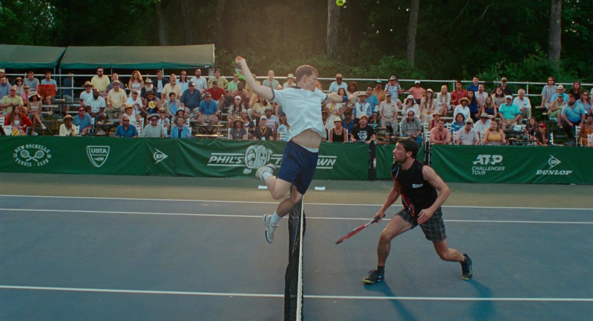 art leaps into the air to hit the ball in challengers