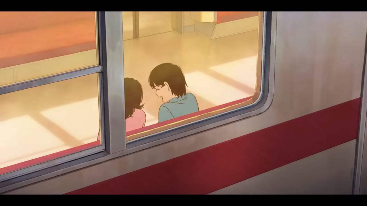 fujino and kyomoto laugh from the inside of a subway train.