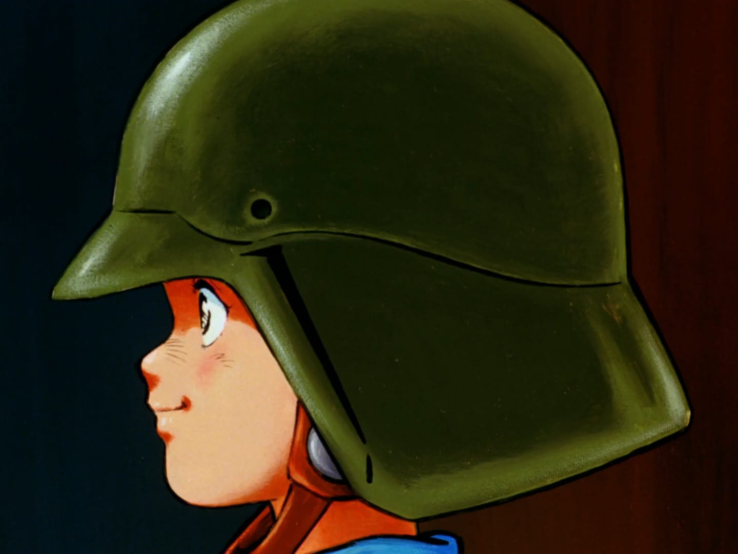 young boy smiling while he wears green military helmet, in side profile