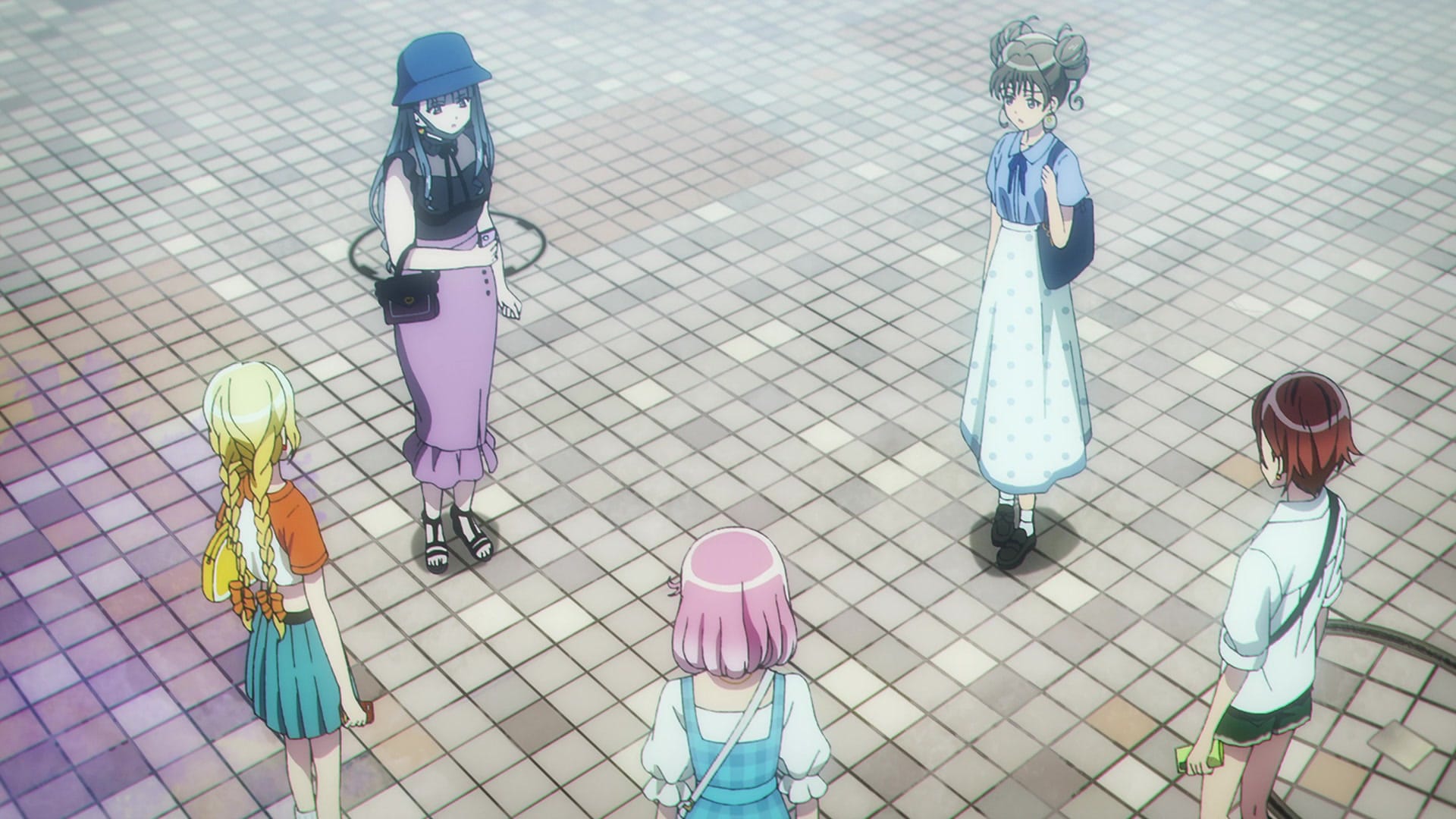 three teenage girls stand in a circle and stare at each other