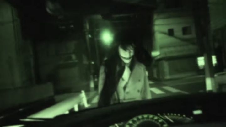 slit mouthed woman framed by car dashboard