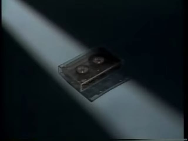 a cassette tape is illuminated by a ray of light.