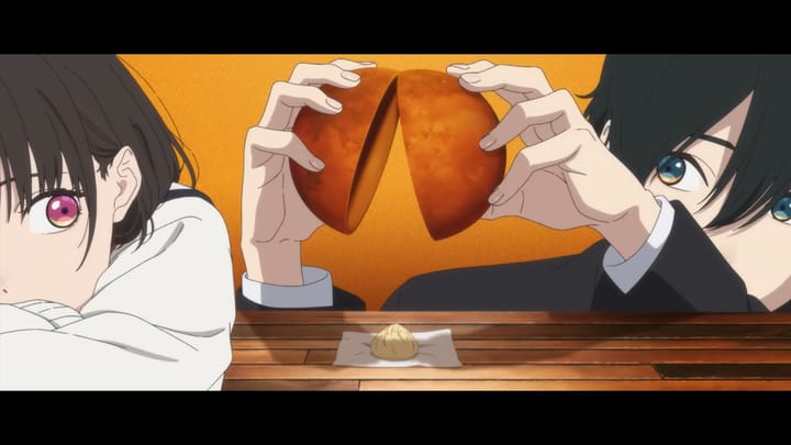 A boy and a girl sit at a table. The boy opens an orange sphere with his hands, depositing a small dumpling onto a piece of paper on the table as if he were cracking an egg.